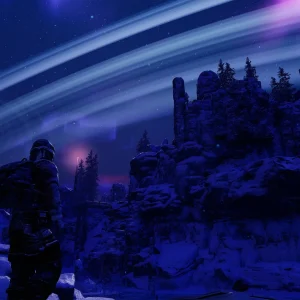 A survivor stands on snowy rocks at night looking at bright rings of moon debris arcing across the sky