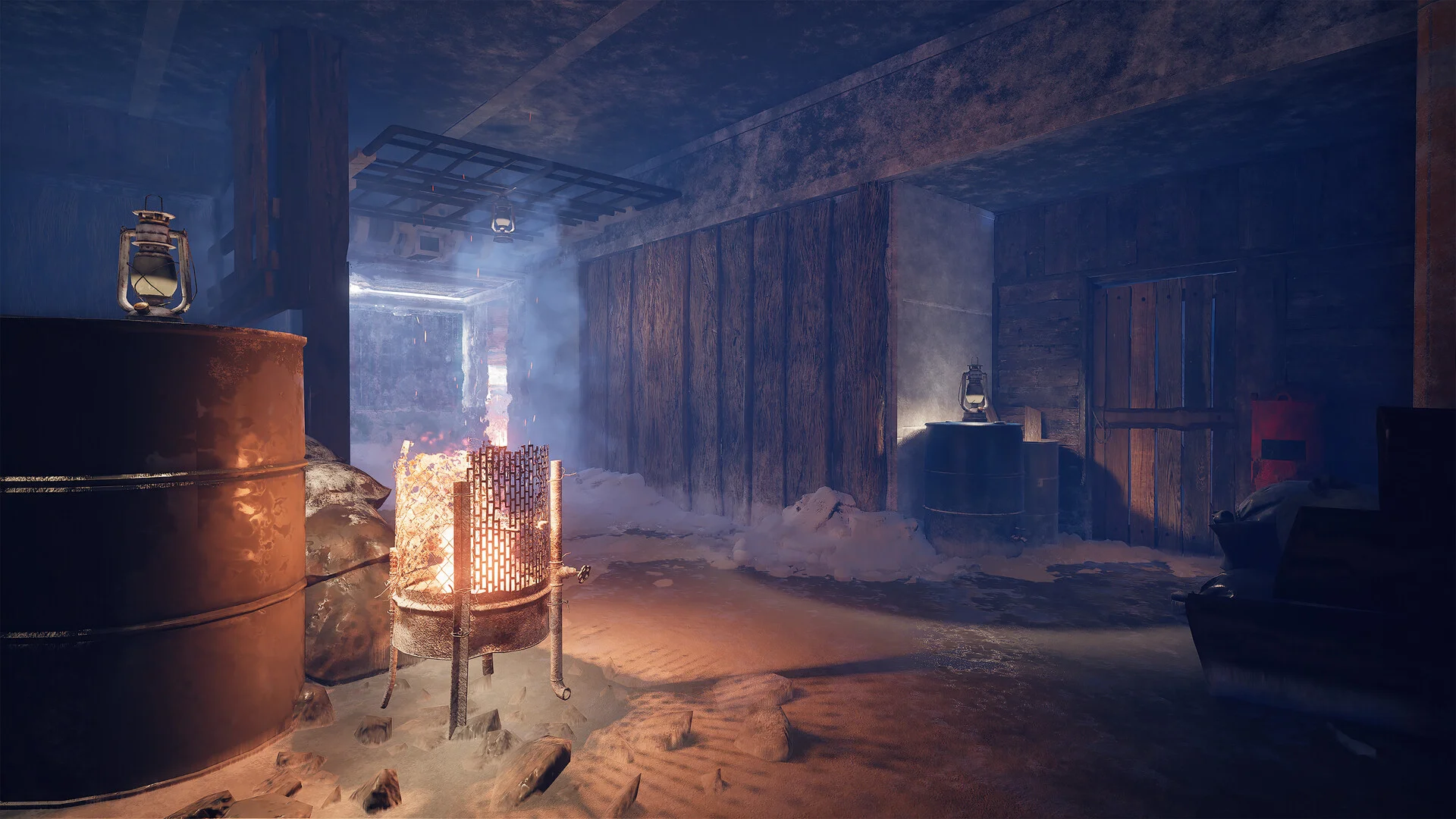 Inside a dark wooden shelter, a fire burns in a metal barrel next to a lantern on an oil drum