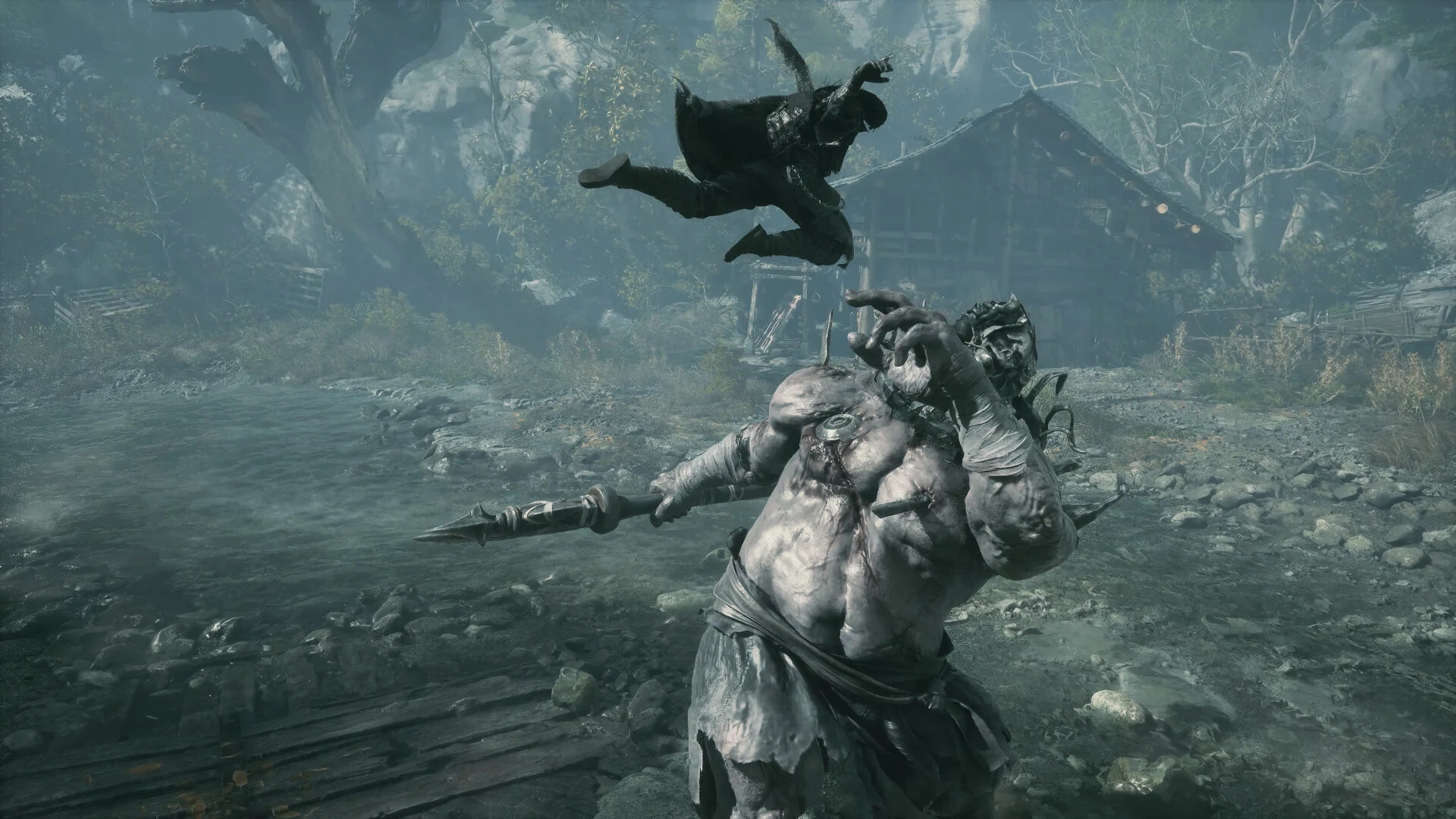 A huge pale brute with a spear lunges while Soul flips through the air above him outside a wooden hall