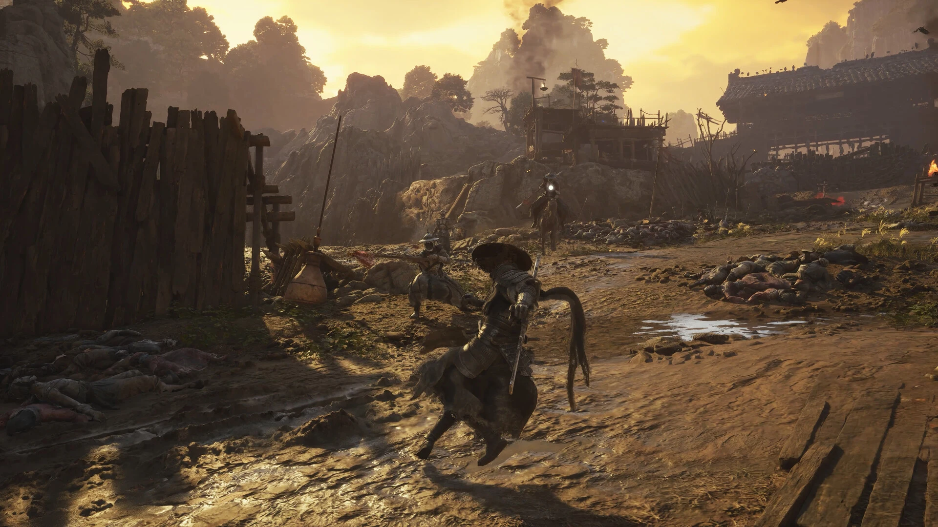Soul fights several enemies in the dusty street of a broken village under a golden evening sky