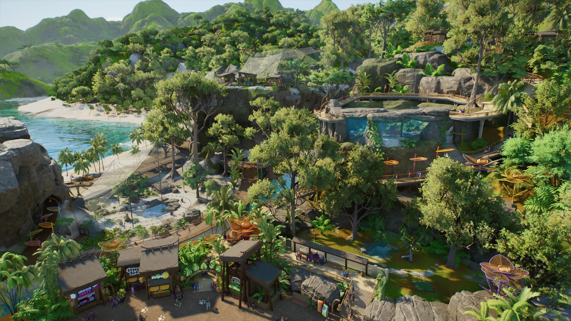 An aerial view of a Planet Zoo 2 zoo built on a tropical coast, with paths, shops, habitats and a beach