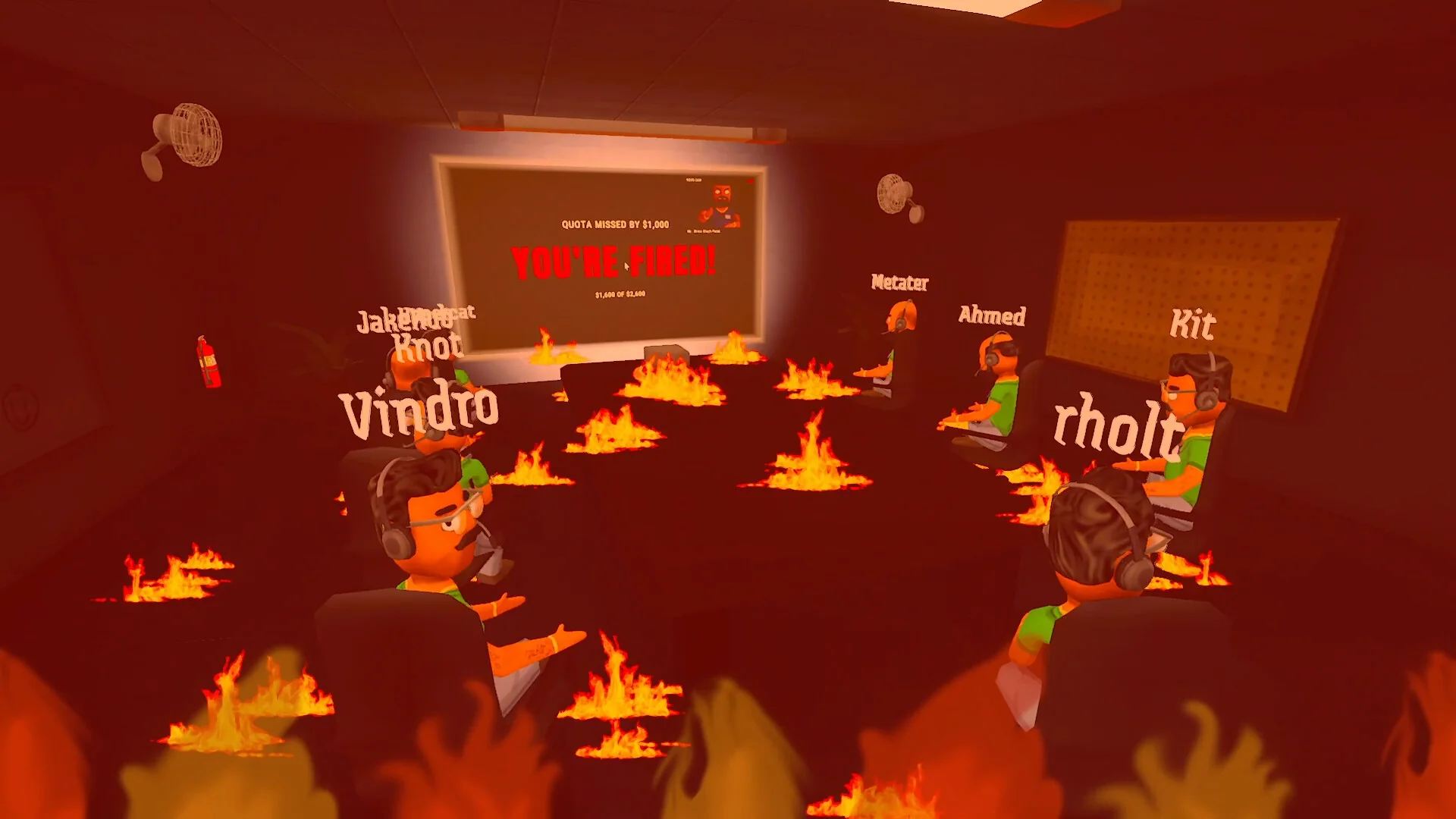 Players watch a big screen at the front of the office during the boss's performance review while flames fill the room