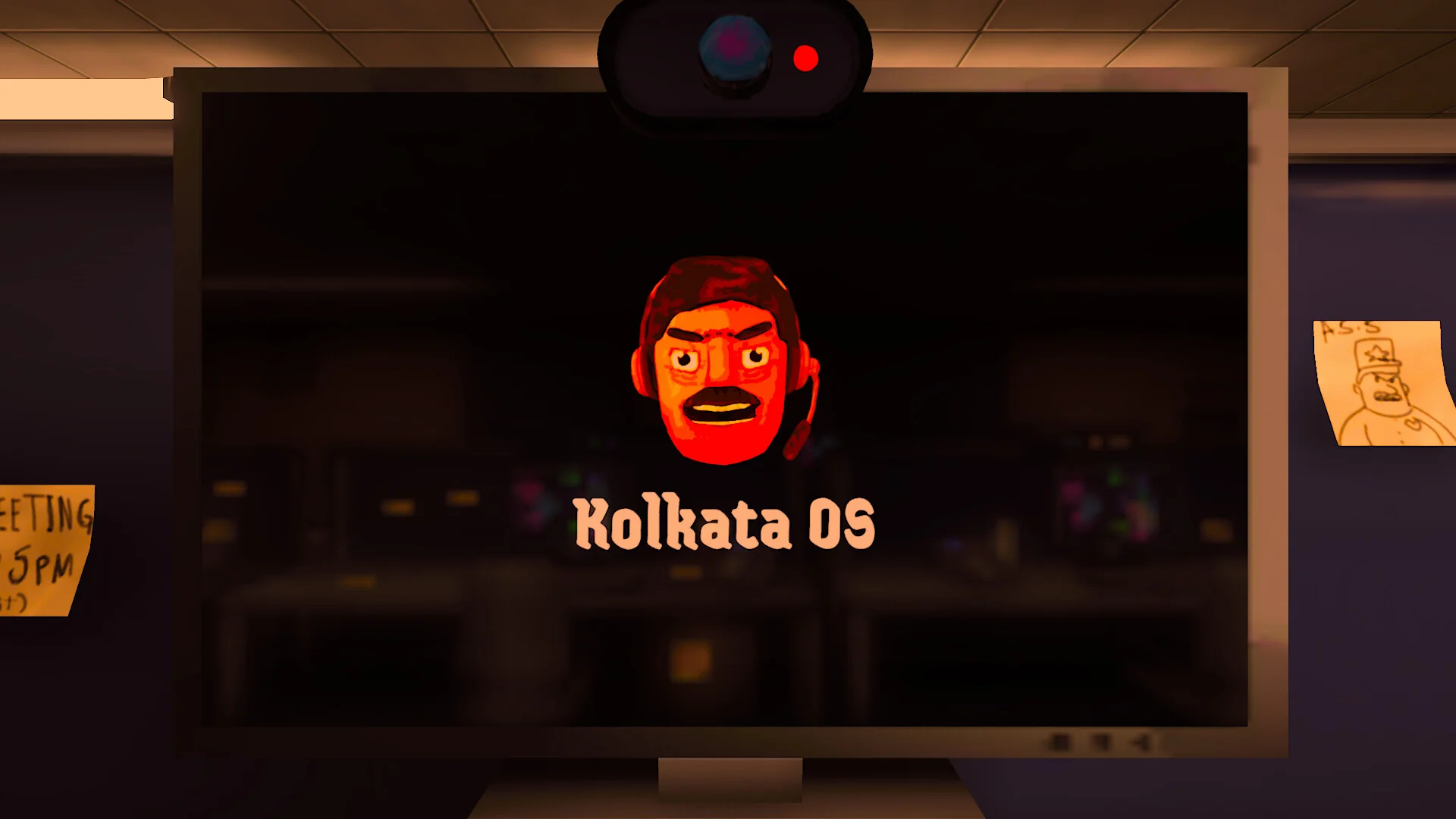 A desk monitor showing the Kolkata OS boot screen with the angry boss's face above the logo