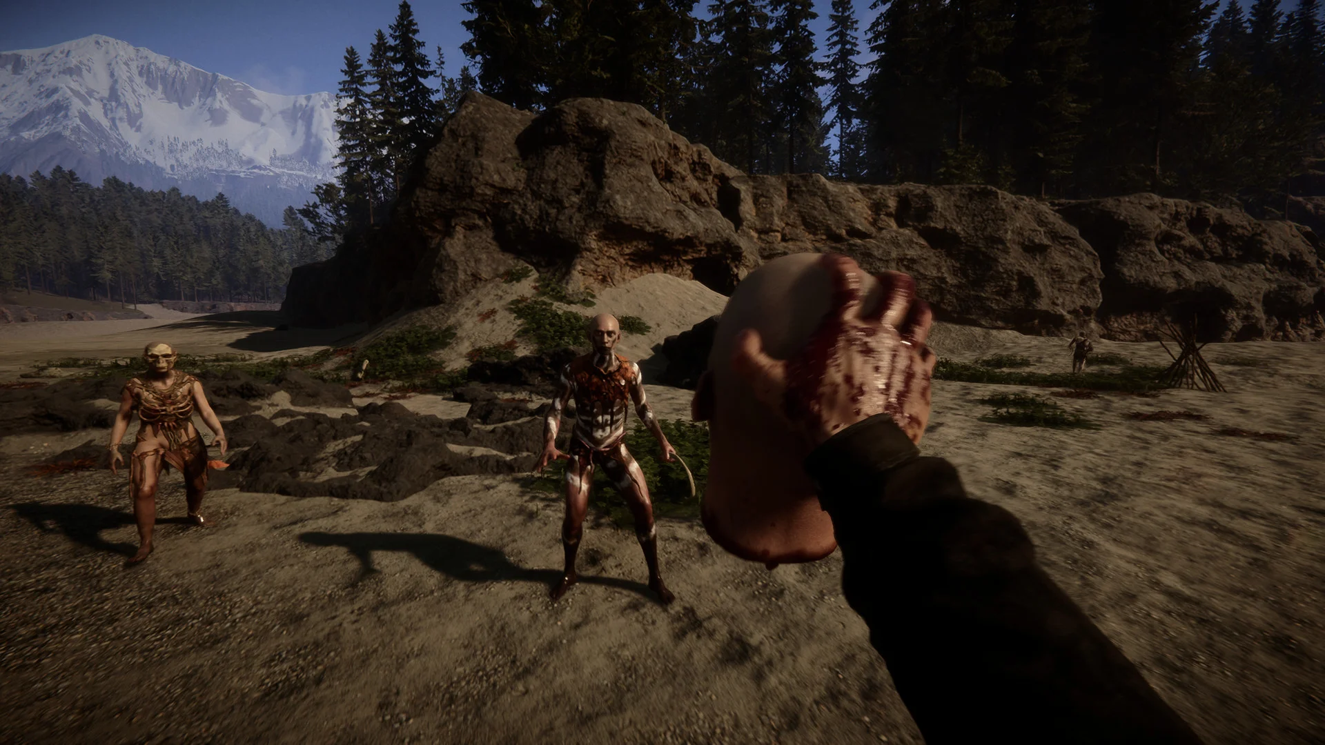 First-person view holding a severed arm as two cannibals approach across a rocky beach below a snowy mountain