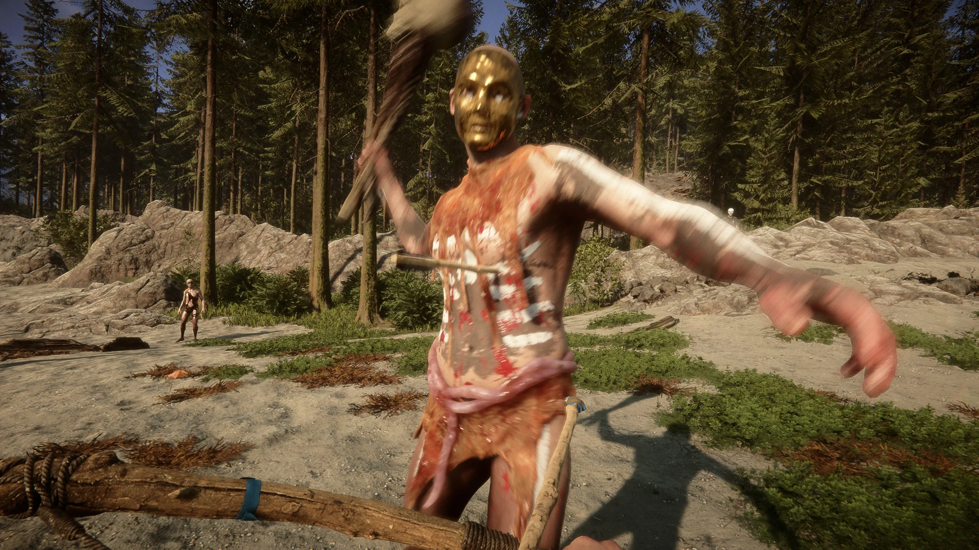 A painted cannibal in a golden mask swings a club at the player on a sandy clearing in the forest
