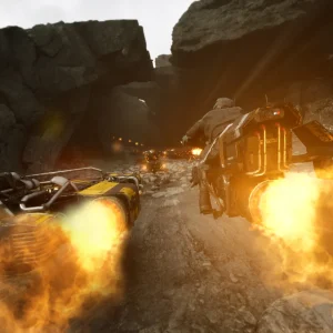 Two speeders fire their boost engines in a burst of flame while racing through a dark rocky cave