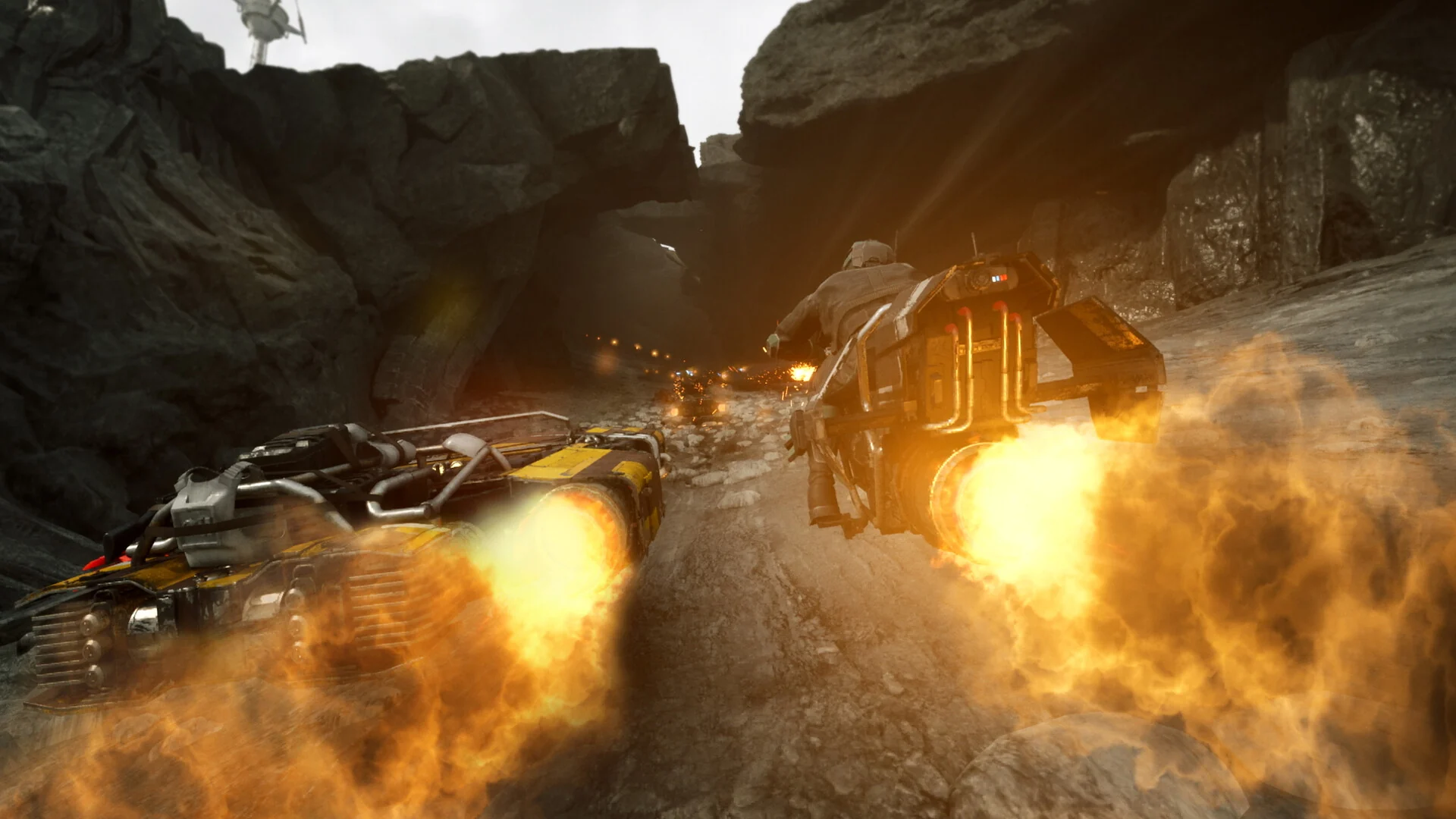Two speeders fire their boost engines in a burst of flame while racing through a dark rocky cave