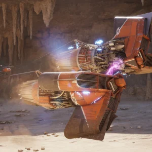 An orange podracer with glowing engines races through a cave lined with stalactites