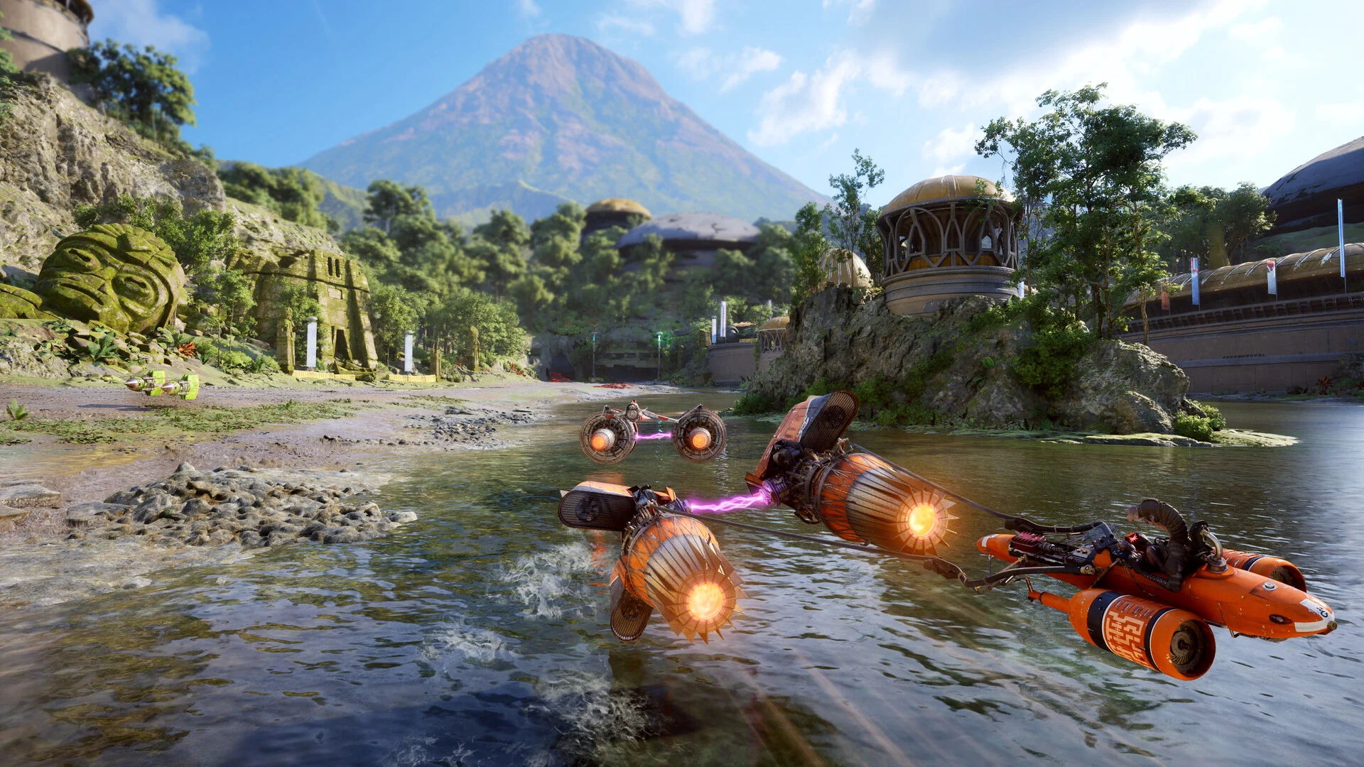 Three orange podracers skim across a shallow river past jungle ruins and a mountain on a tropical race course