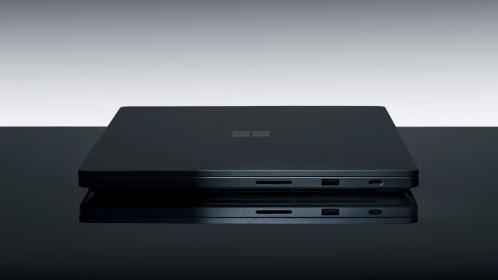 Surface Laptop Ultra closed, seen from the side with the Microsoft logo on the lid and ports along the edge