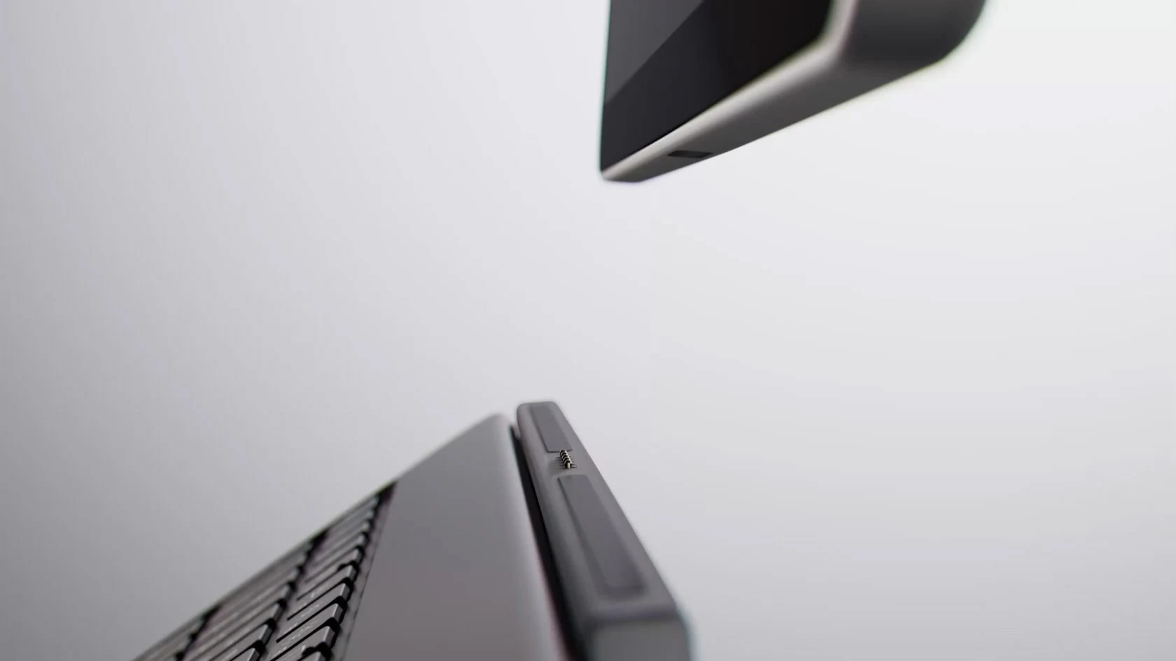 A Platinum Surface Pro floating above its detached keyboard, seen from below
