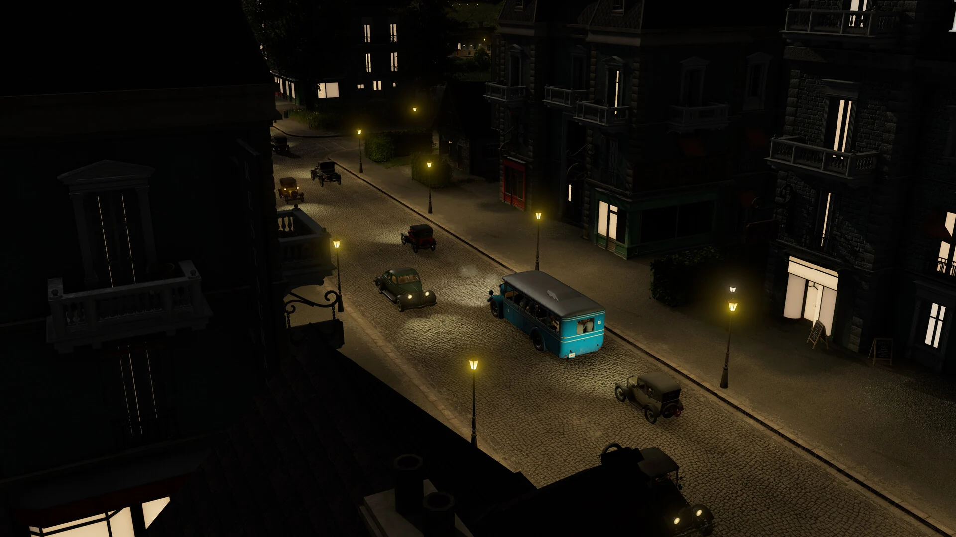 A narrow city street at night in an early era of Transport Fever 3, lit by gas lamps, with vintage cars and a blue bus driving past brick buildings