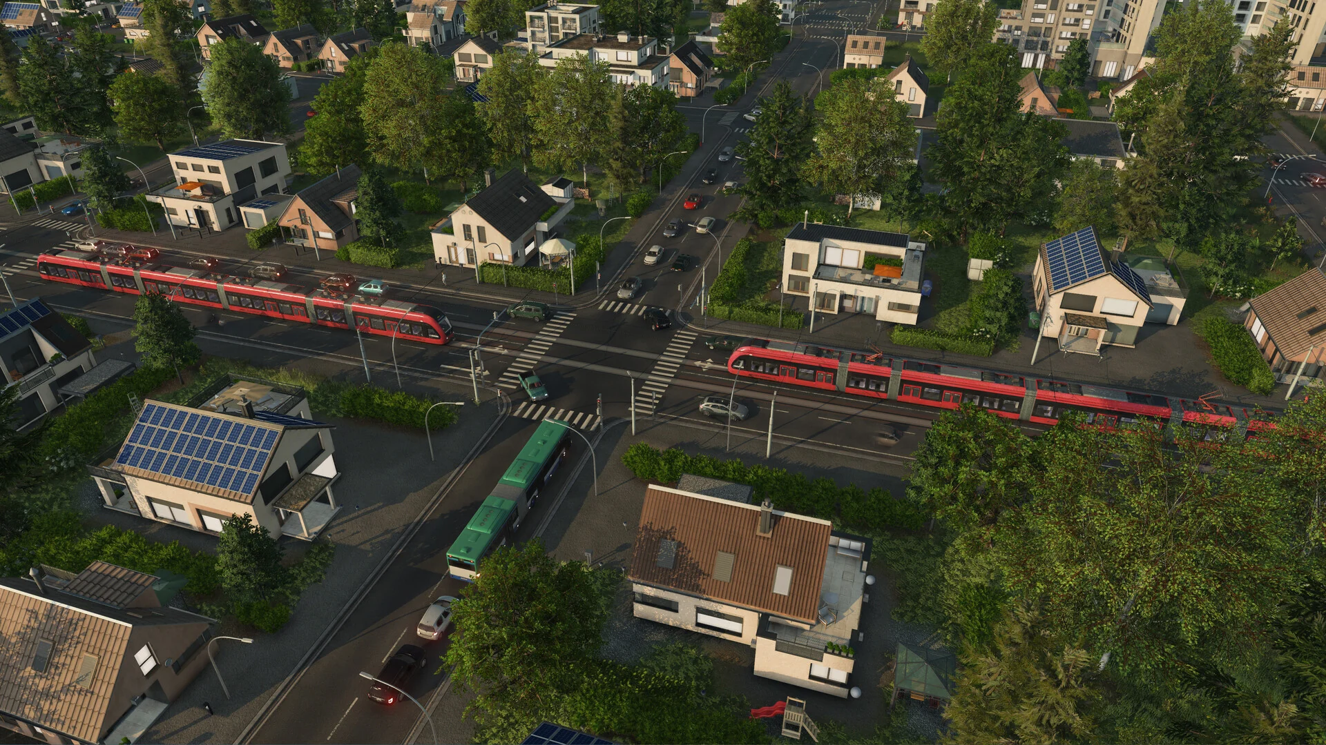A modern Transport Fever 3 town from above, with red passenger trains crossing streets of houses with solar panels and a green tram passing below